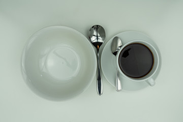 White dishes, silver cutlery and coffee