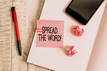 Text sign showing Spread The Word. Business photo text share the information or news using social media Thick pages notebook stationary placed above classic look wooden backdrop