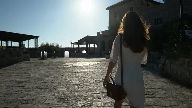 young woman walks the streets of the old city of Ulcinj