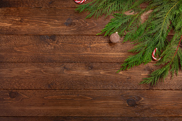 Minimal christmas composition. Cypress branches witn decor, on dark wooden  background. Christmas, winter concept. Flat lay, top view.