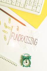 Handwriting text writing Fundraising. Conceptual photo seeking to generate financial support for charity or cause Flat lay above white blank paper with copy space for text messages