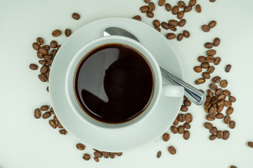 Hot coffee in a cup and coffee  beans
