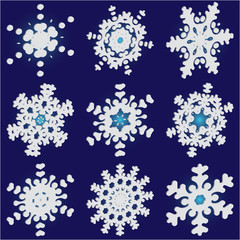 Fototapeta na wymiar Kit of simple christmas snowflakes on blue background.