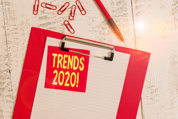 Word writing text Trends 2020. Business photo showcasing general direction in which something is developing or changing Clipboard paper sheet sticky note ballpoint clips vintage wooden background