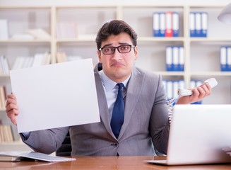 Fototapeta premium Businessman in office holding a blank message board