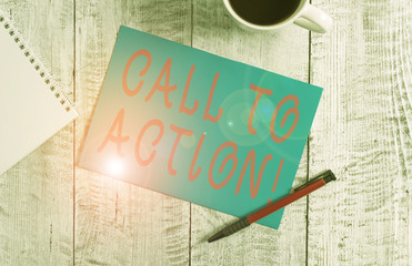 Text sign showing Call To Action. Business photo text exhortation do something in order achieve aim with problem Stationary placed next to a cup of black coffee above the wooden table