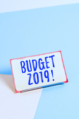 Text sign showing Budget 2019. Business photo showcasing estimate of income and expenditure for current year Paper placed tilted above buffer wire on soft pastel multi colours backdrop