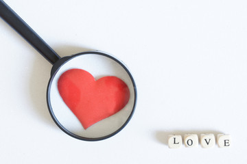 Red heart and the inscription love next to a fountain pen and notepad made of eco friendly paper. Form prepared for filling and inscriptions. Happy Valentine's Day Greeting Card