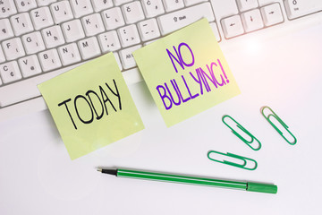 Word writing text No Bullying. Business photo showcasing stop aggressive behavior among children power imbalance Square green note paper with pencil on the white background