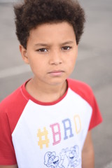 African american cute schoolboy looking in the camera. Children outside. Kids portrait