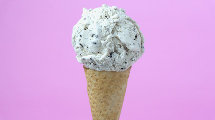 scoop Ice cream cookies & Cream in waffle cone on pink background, Closeup Front view Food concept.