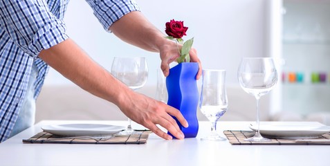 The man alone preparing for romantic date with his sweetheart