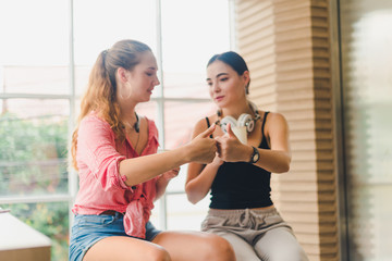 Two beautiful young women drinking coffee and talking together. concept of relaxation.