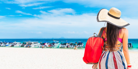 Fototapeta na wymiar Traveler woman in summer dress with backpack joy relaxing on white sand beach, Bamboo island, Andaman sea, Krabi, near Phuket, Travel Thailand, Beautiful destination Asia, Summer holiday vacation trip