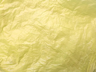 Crumpled yellow plastic bag, abstract texture background
