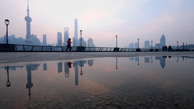 Silhouette of people running at The Bund in Shanghai in the morning, China, 4k footage, slow motion.