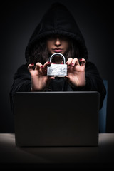 Female hacker hacking security firewall late in office