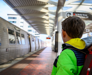 Young Caucasian boy watching Washington DC metro train depart