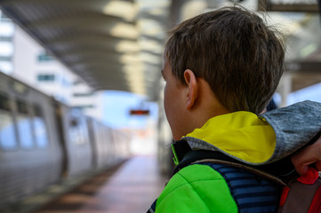 Young Caucasian boy watching Washington DC metro train depart