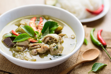 Thai green curry chicken in bowl on wooden background, Thai food