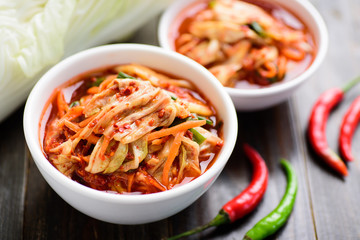 Kimchi cabbage in bowl on wooden background, Korean food