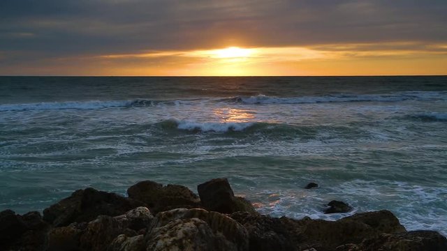 An ocean surf sunset on the Gulf of Mexico is featured in this looping video shot on Captiva Island, Florida