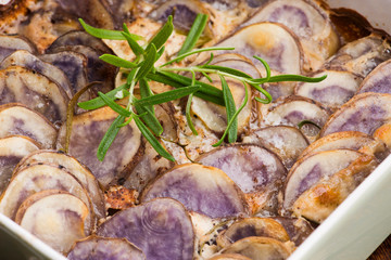 Violet potato gratin with cream and rosemary
