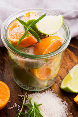Preserved Lime and Mandarin with salt on a wooden board