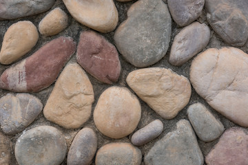 Fototapeta na wymiar Colorful stone wall texture of various shapes
