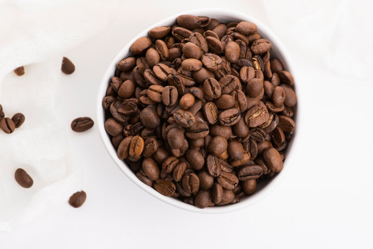 Bowl of caffee beans on a white background