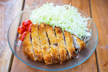 Tonkatsu fried pork served with cabbage and tomato