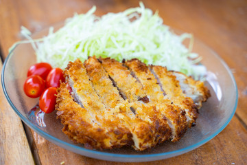 Tonkatsu fried pork served with cabbage and tomato