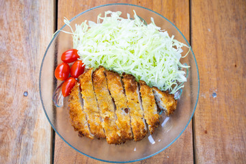 Tonkatsu fried pork served with cabbage and tomato
