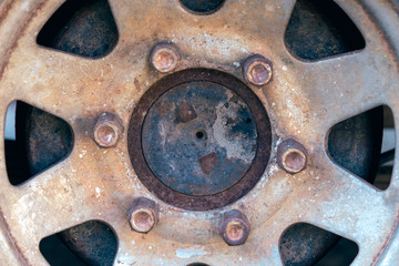 Obraz na płótnie Canvas Close up of rusty hubcap of abandoned car. 
