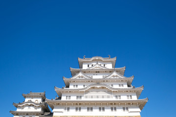 The Himeji castle with angle of elevation and blue sky, an UNESCO World Heritage site, is the most visited castle in Himeji, Japan.