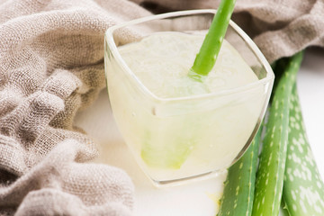Glassware with fresh aloe vera juice and leaves