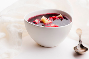 Christmas beetroot soup, borscht with small dumplings with mushroom filling