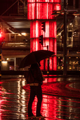 Stockholm, Sweden A woman with an umbrella in the rain at Sergels Torg.