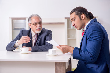 Two businessman discussing business in office