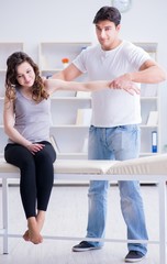 Fototapeta na wymiar Young doctor chiropractor massaging female patient woman