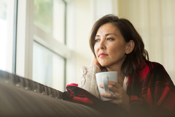 Portrait of a mature Asian woman in deep thought.