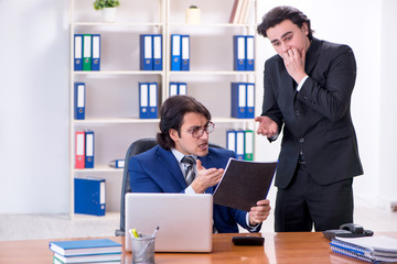 Boss and his male assistant working in the office