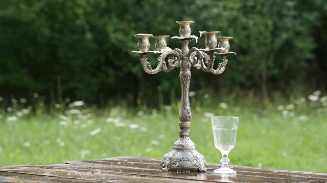 antique candlestick on the table in the rain