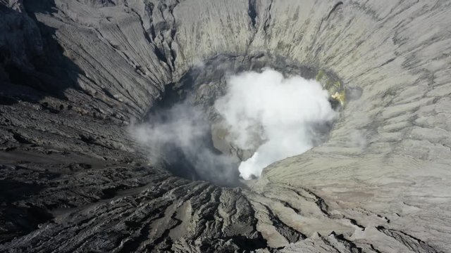 Mount Bromo crater with volcanic smoke