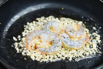 fried shrimp in sauce, fried in oil in a pan with spices, seafood