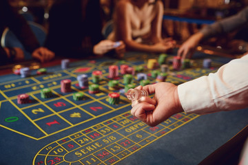 Croupier hand indicates the winning sector on the roulette table.
