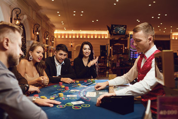 People gamble at a poker table in a casino