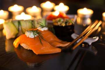  Various sushi close-up in the light of candles