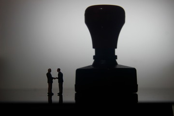 Dramatic Lighting, Simple Illustration Photo, Silhouette Two Man Handshaking for Business Agreement...