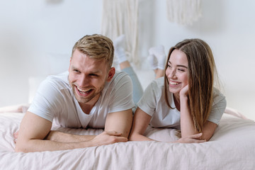 Young adult family spending morning in bedroom